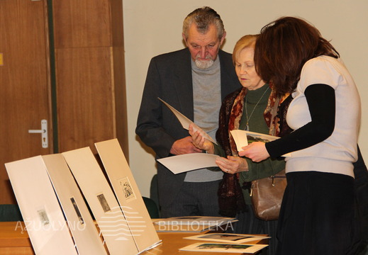 Svečiai apžiūri fotografijas su G. Didelyte